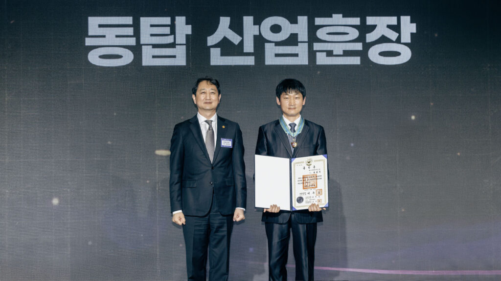 (from left) Minister Ahn and Song, shown with his award